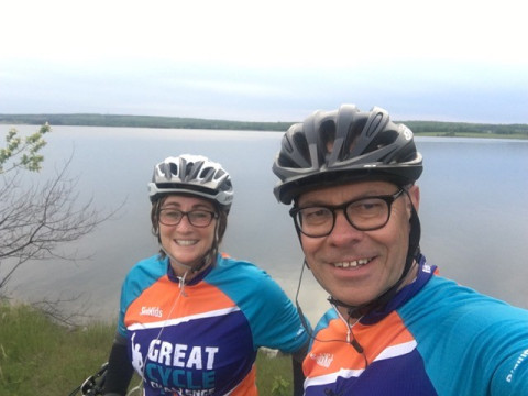 Happy physician and spouse enjoying a bike ride in Nova Scotia