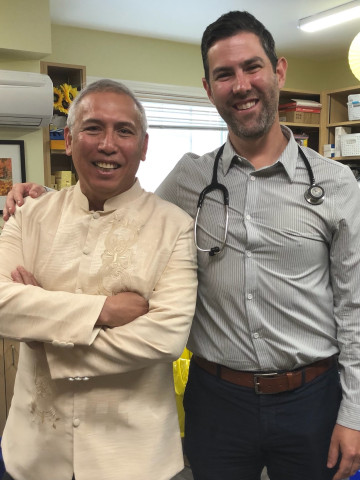 Two doctors stand together in a clinic