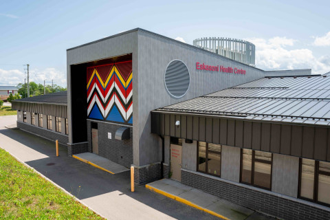 a grey building with a colourful pattern on the front