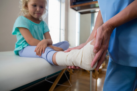 Child getting their ankle wrapped