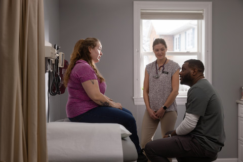 three people in a doctors office