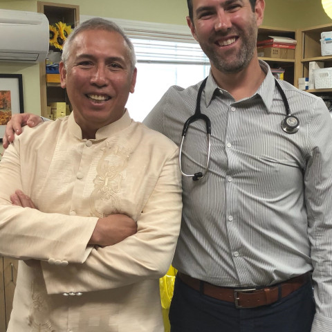 Two doctors stand together in a clinic