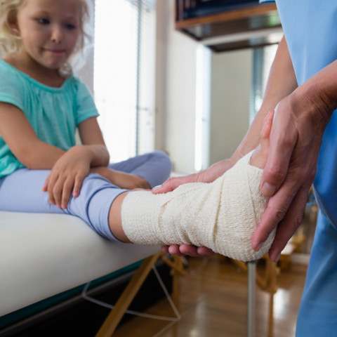 Child getting their ankle wrapped